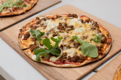 PitZar wood-fired pizza topped with melted cheese, minced beef and rocket