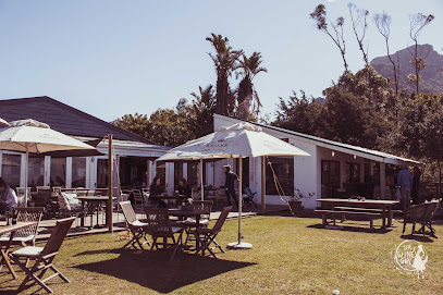 Outdoor dining at Silvermist Organic Wine Estate patio with umbrellas and tables