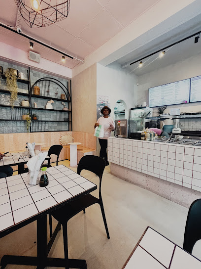 The Poke Co. Claremont interior with staff at counter and tiled tables