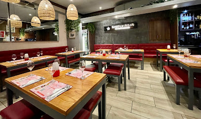 Simply Asia Heritage Square dining room with wooden tables, red booths, rattan pendant lights