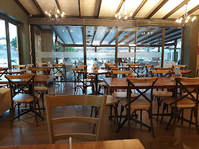 Willows Caffe dining area with wooden tables, chairs and chandeliers