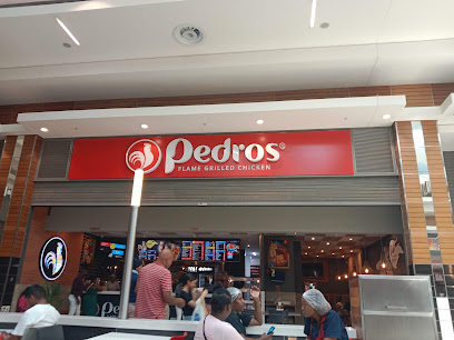 Pedros Promenade Mall storefront with red 'Pedros' flame-grilled chicken sign and diners