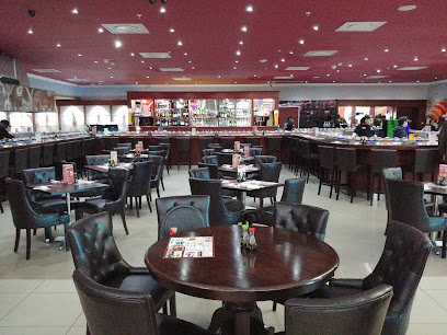 Asami's Tygervalley sushi restaurant dining room with dark wood tables and bar