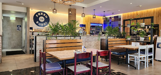 Ocean Basket Sea Point dining area with wooden booths and sushi sign