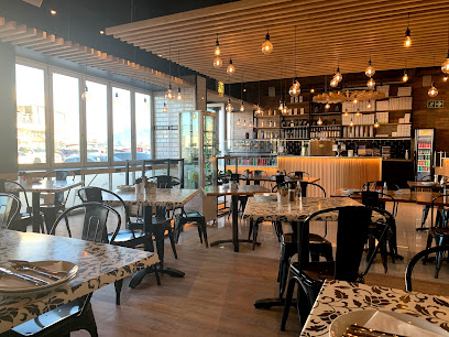 Ciao Pizza Blouberg bright dining room with wooden bar and tables