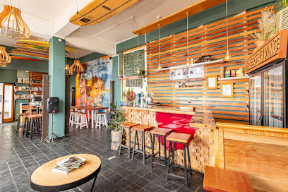 The Commons dining room with wooden slatted wall, red bench, bar stools, pendant lights