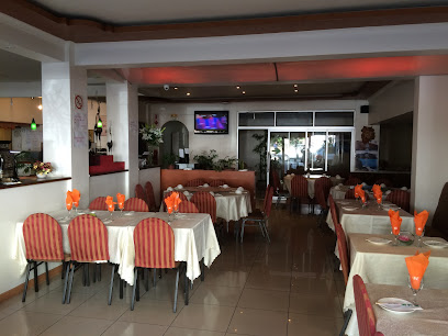 Empire Asian Restaurant dining room with neatly set tables and orange napkins