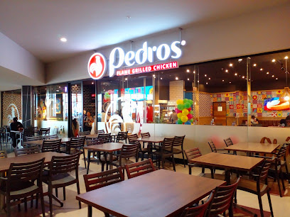 Pedro's flame-grilled chicken storefront and empty mall seating at Bayside Mall