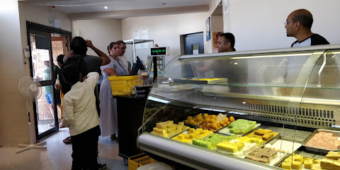 Shayona Cape Town counter with glass display of sweets, customers queuing