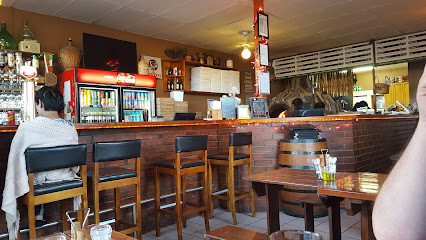 Portalia Pizzeria & Deli interior with bar counter, stools and wooden tables