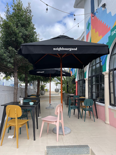Nourish’d Café Green Point patio with neighbourgood umbrellas and pastel chairs