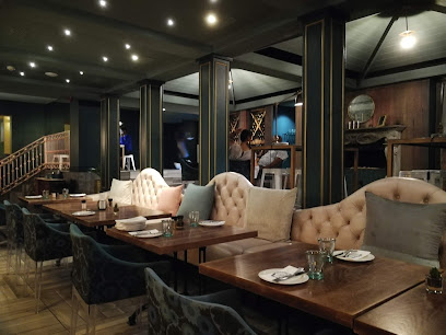 Strolla Restaurant & Bar dining room with tufted banquettes and wooden tables