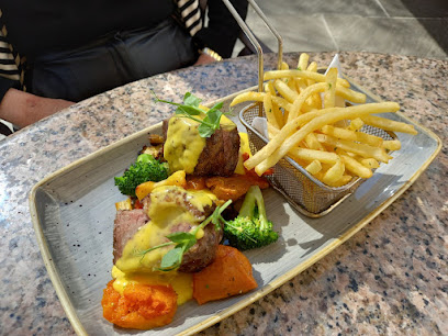 Plated steak medallions with hollandaise, roasted squash, broccoli and fries at Garden Lounge, Vineyard Hotel