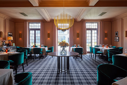 BLOOM Restaurant dining room at Stefan's with teal chairs and chandelier