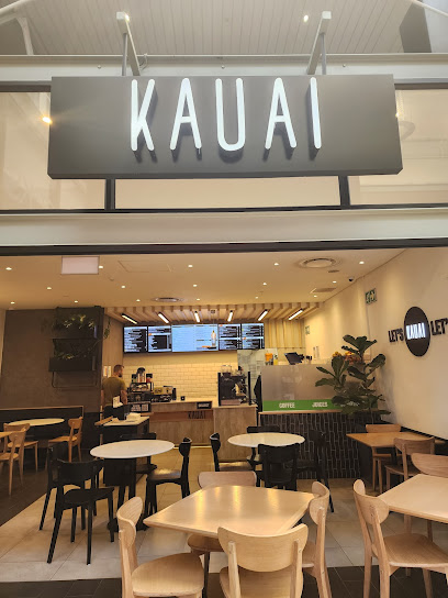 KAUAI restaurant storefront at Paddocks Mall with seating and menu counter