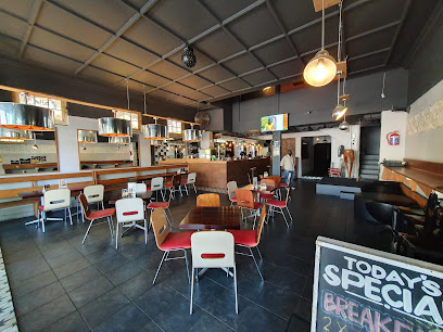 Locomotion Coffeatery interior with tables, counter and chalkboard specials