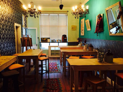 Ferdinando's Pizza cozy dining room with wooden tables and chandeliers