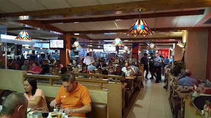 Busy Silver Spur dining room with seated diners and servers