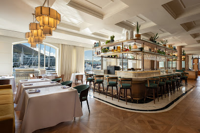 Heirloom Restaurant dining room with central marble bar and waterfront views