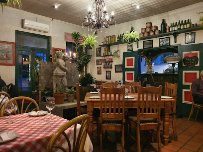 Bardelli's Restaurant cozy dining room with wooden tables, chandelier, plants.