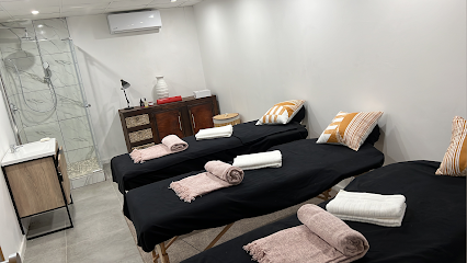 MyPumpkin treatment room with three massage beds, rolled towels and pillows