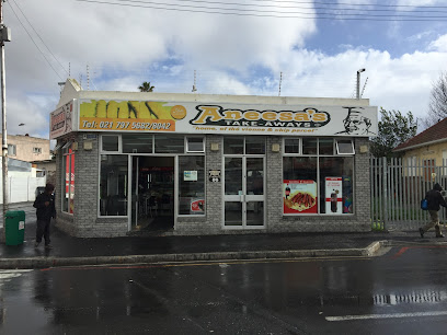 Aneesa's Takeaways Wynberg storefront with yellow signboard on wet street