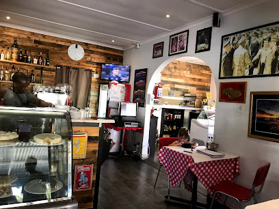 Dario's Cafe interior with glass pastry display, service counter and checkered table