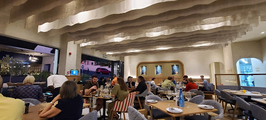 Interior of Mythos Greek Restaurant Majik Forest with diners at tables