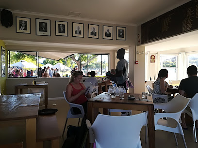 Guests dining inside The Club House at Claremont Cricket Club, windows overlooking the cricket oval
