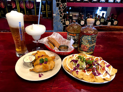 The Fat Cactus Gardens Mexican spread: nachos, fried fish, churros, frozen margarita, beer and tequila