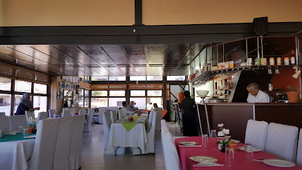 Bo-Kaap Kombuis dining interior with set tables and staff behind counter
