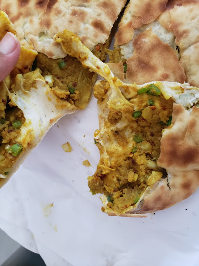 Mitchells Plain Food Bazar stuffed flatbread torn open with curried potato and peas