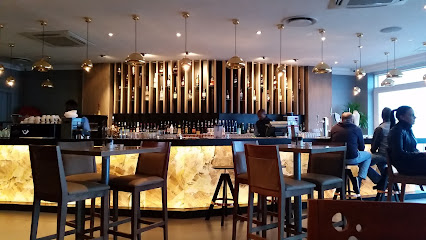 News Cafe Table View interior, bar counter with backlit stone front and seating