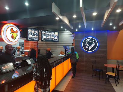 Chicken Licken Mowbray counter with illuminated menu, staff and customers