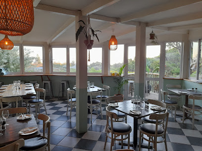 Limoncello Ristorante dining room with set tables, pendant lights and seaside views