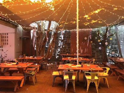 Izakaya Matsuri outdoor dining area under lit canopy with wooden tables and string lights