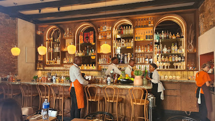 Hacienda Coastal Mexican bartenders preparing cocktails behind a wooden bar