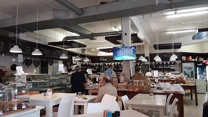 Martin’s Bakery interior with pastry counters, tables, and customers