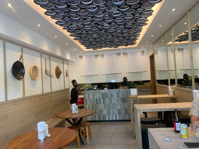 Noodle Box Newlands interior with front counter, staff and wooden seating