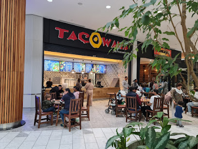 Tacowama restaurant counter and dining area in mall with seated customers