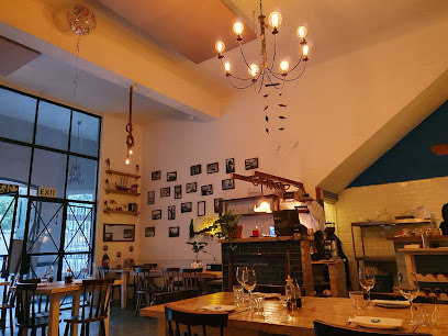 Riva Fish Restaurant interior in Simon's Town — wooden tables, chandelier
