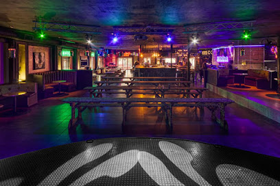 Harley’s on Main interior with communal benches, bar and colored lighting