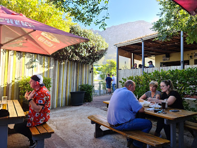 Al fresco seating at The Toad on the Road pub with patrons at picnic tables