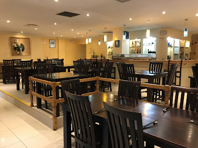 Sushiyama Asian Cuisine Fish Hoek dining room with wooden tables and sushi bar