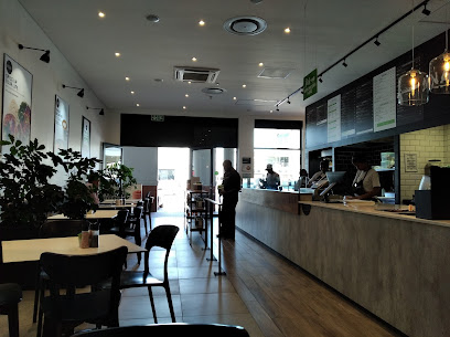 Kauai Durbanville café interior with counter, menu boards, staff and seating