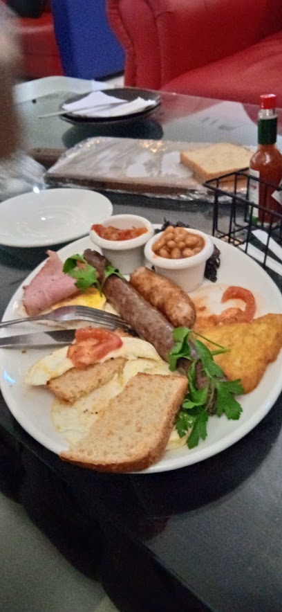 Kwa Ace eKitcheni plated meal with sausage, baked beans, bread, fried egg