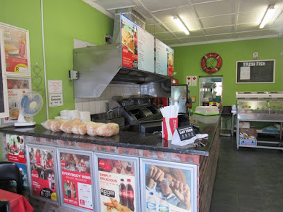 Blue Wave Fisheries takeaway counter with fryers, menu boards and bread rolls