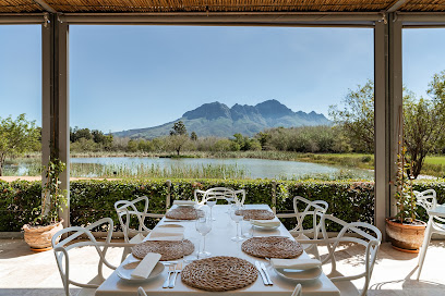 Dining table at The Restaurant at Morgenster with lake and mountain view