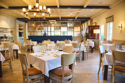 Peddlars pub dining room with white-tablecloth tables set for service