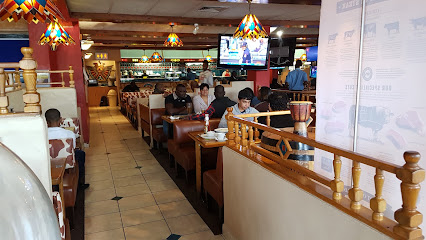 Reno Spur dining room with wooden booths, diners and TV screens